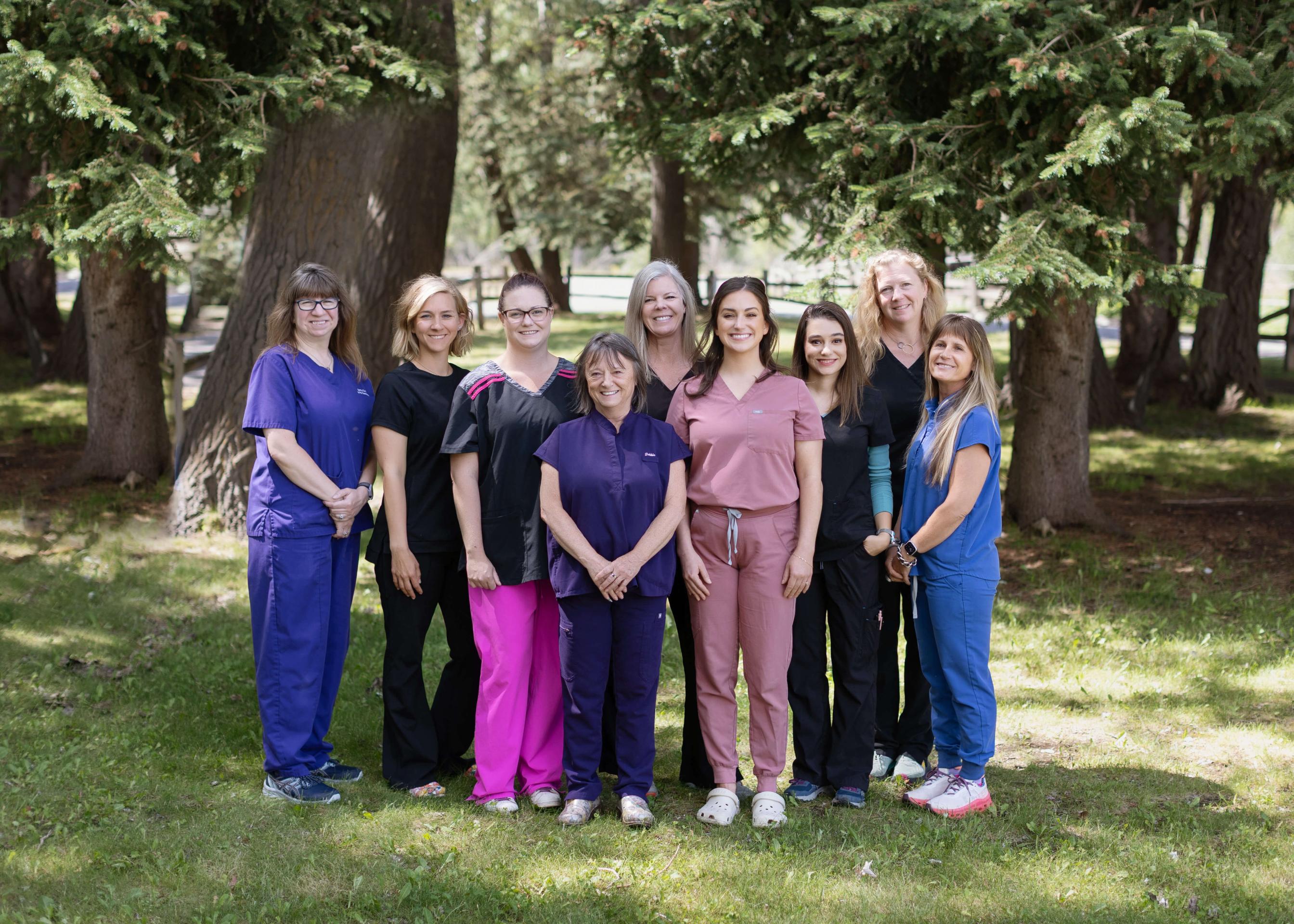 team of veterinary professionals standing outside in a group.